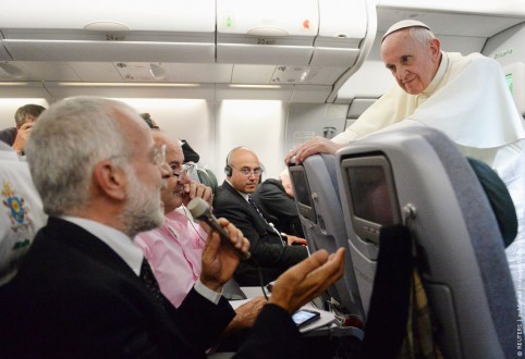 Pope Francis listens to journalist's questions as he flies back to Rome following his visit to Brazil
