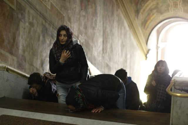 People pray on Holy Stairs at Pontifical Sanctuary of the Holy Stairs in Rome